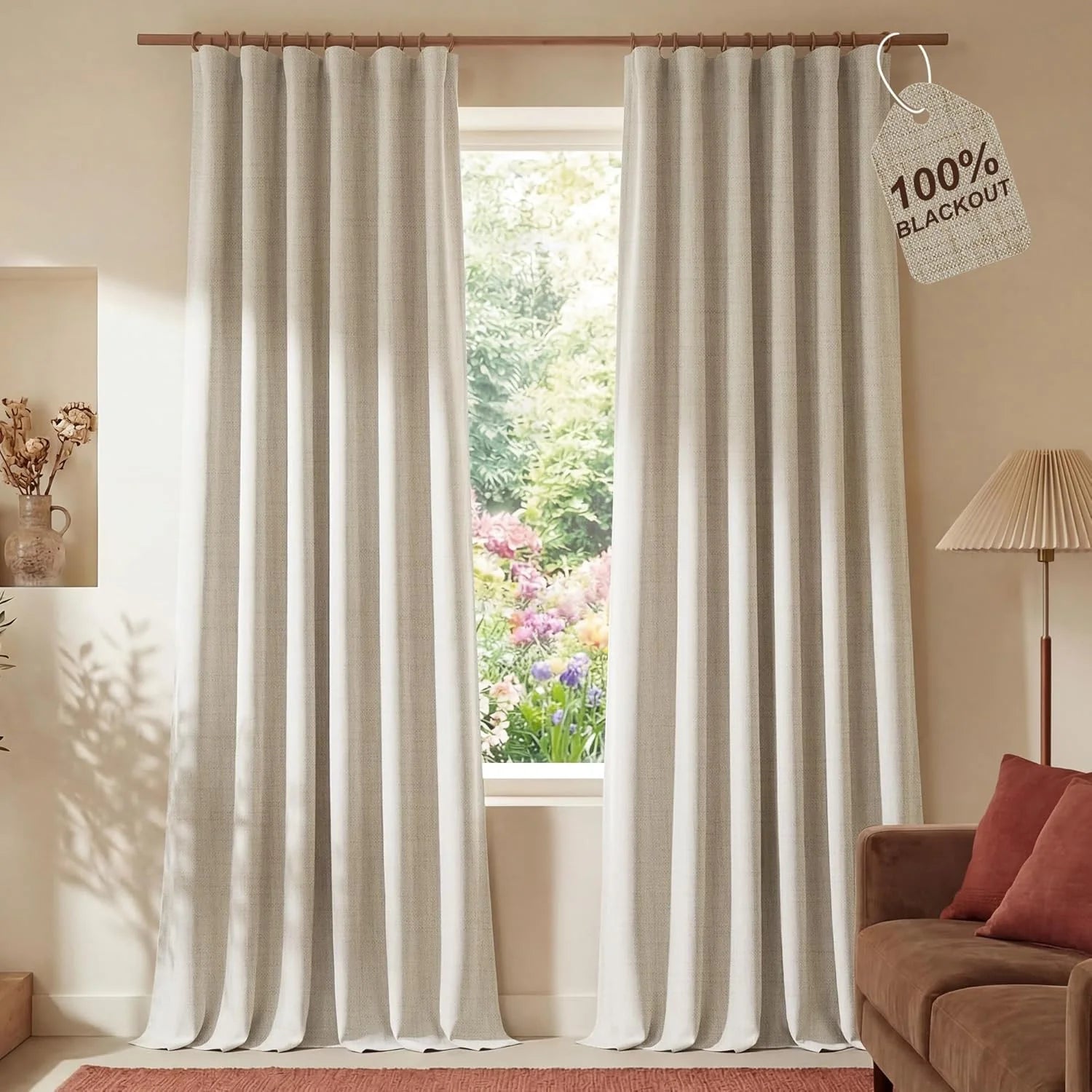 Floor-length light beige 100% blackout curtains with woven texture in a modern living room.