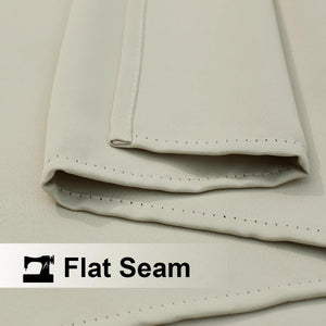 Close-up of light beige fabric, likely a curtain, showcasing a neatly stitched flat seam detail.