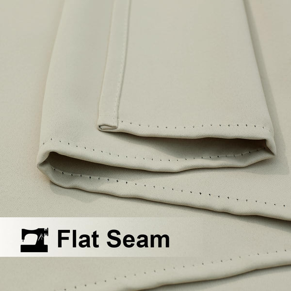 Close-up of light beige fabric, likely a curtain, showcasing a neatly stitched flat seam detail.