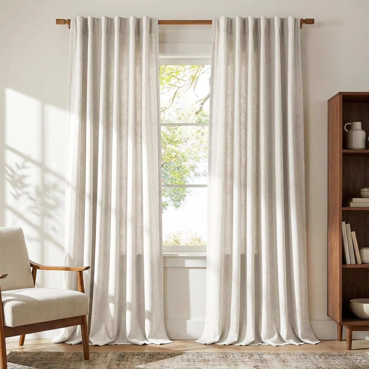 Light beige linen curtains on a wooden rod in a modern sunlit room