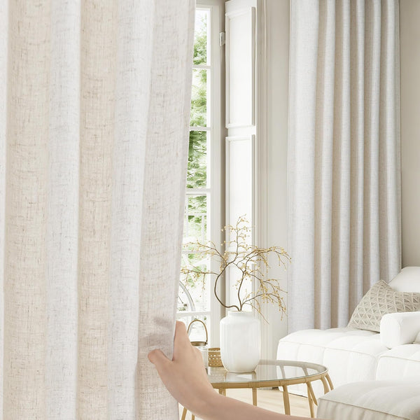 Light beige linen pleated curtains with natural texture filtering soft light in modern living room.
