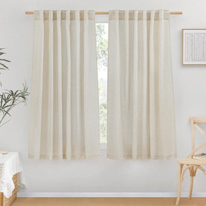 Light beige linen tab top curtains hanging on a wooden rod, creating a natural, rustic aesthetic.