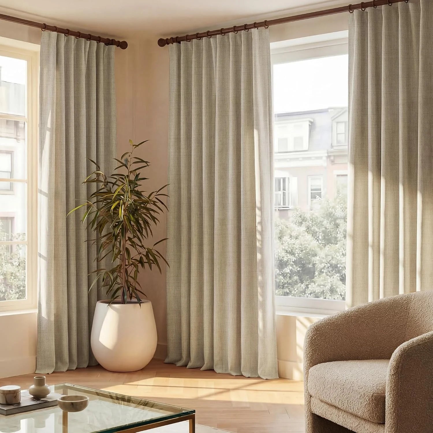 Light beige pleated curtains on wood rods in a bright, modern living room.
