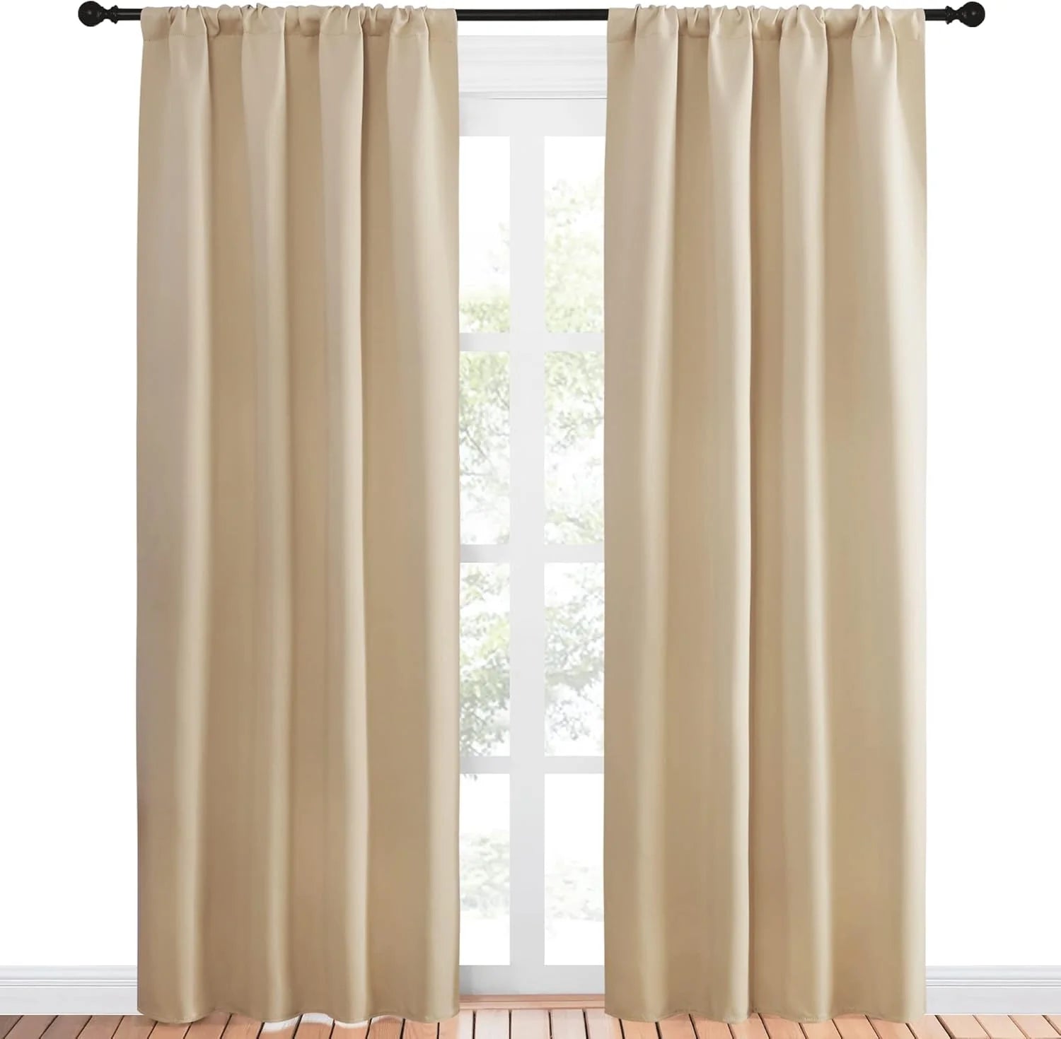 Pair of light beige rod pocket curtain panels on black rod in window