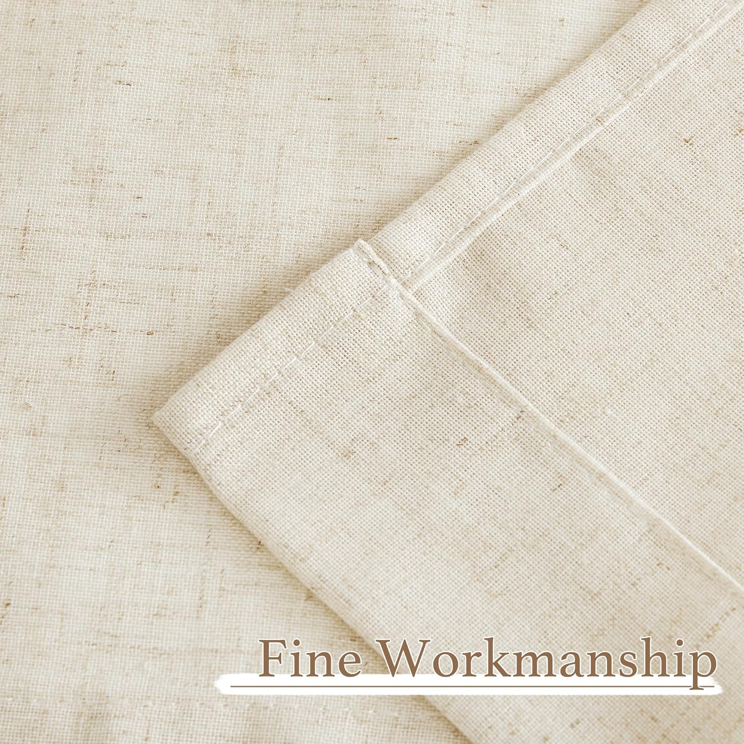 Detailed close-up of light beige natural linen fabric, showing visible texture and fine stitching on a folded edge.
