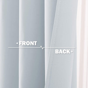 Close-up of light blue blackout curtain fabric, showing smooth front and textured back.