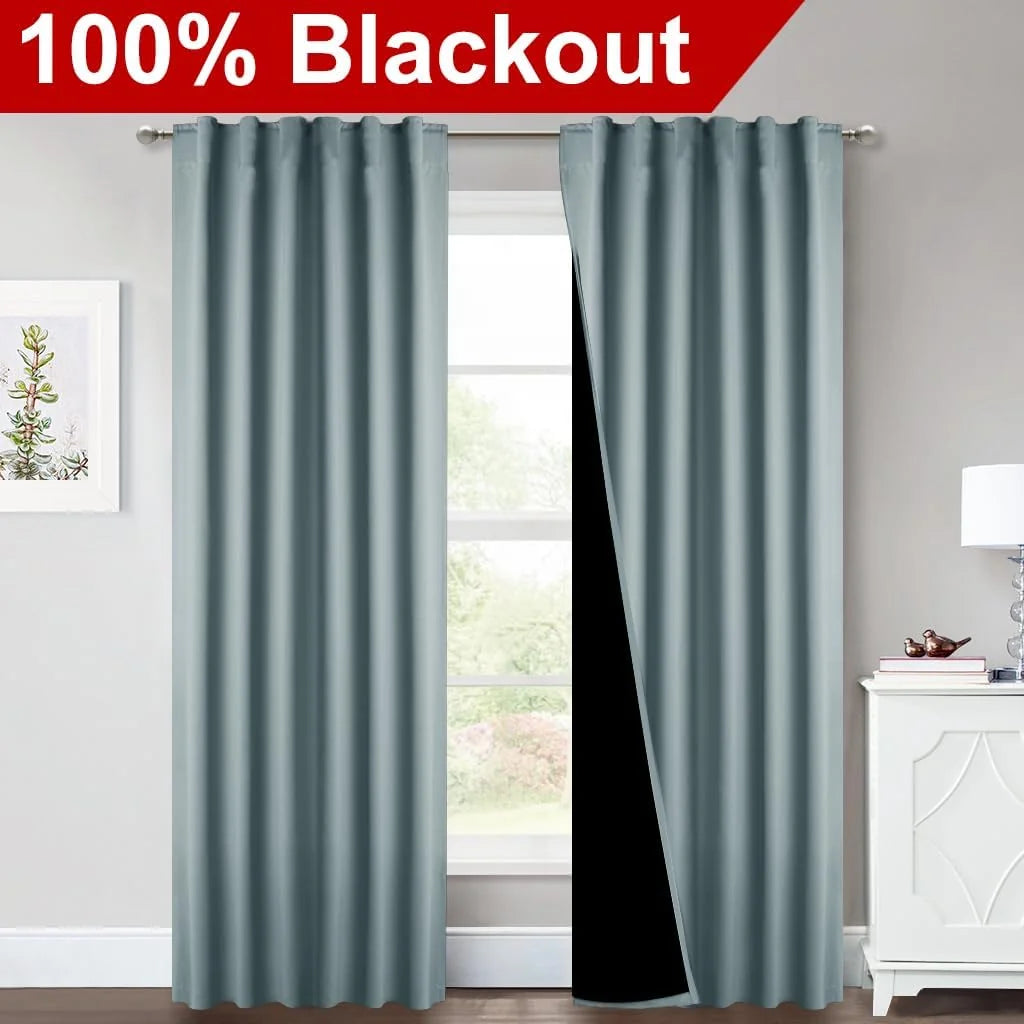 Light blue blackout curtains on a silver rod in a bright modern room window
