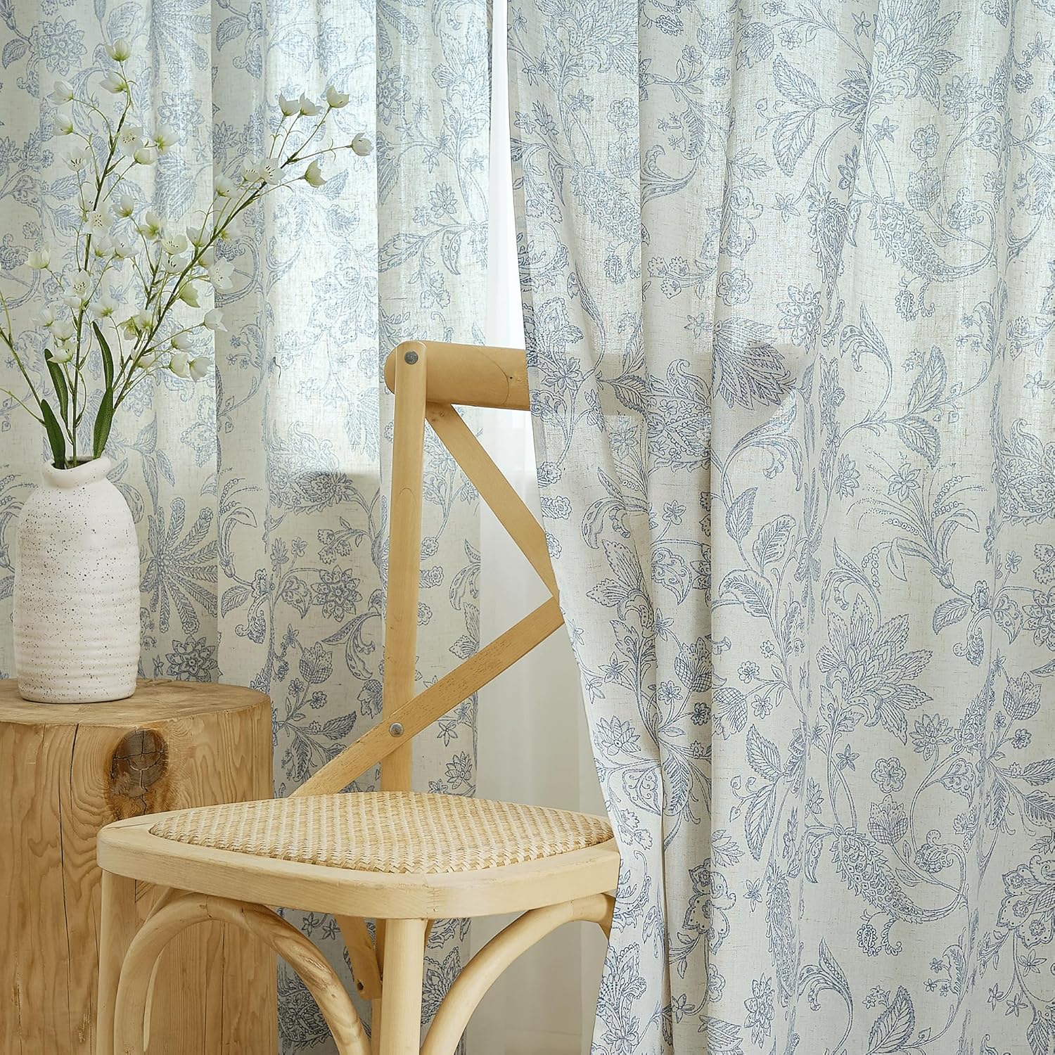 Light blue floral linen blend curtains with detailed botanical pattern against an off-white background.