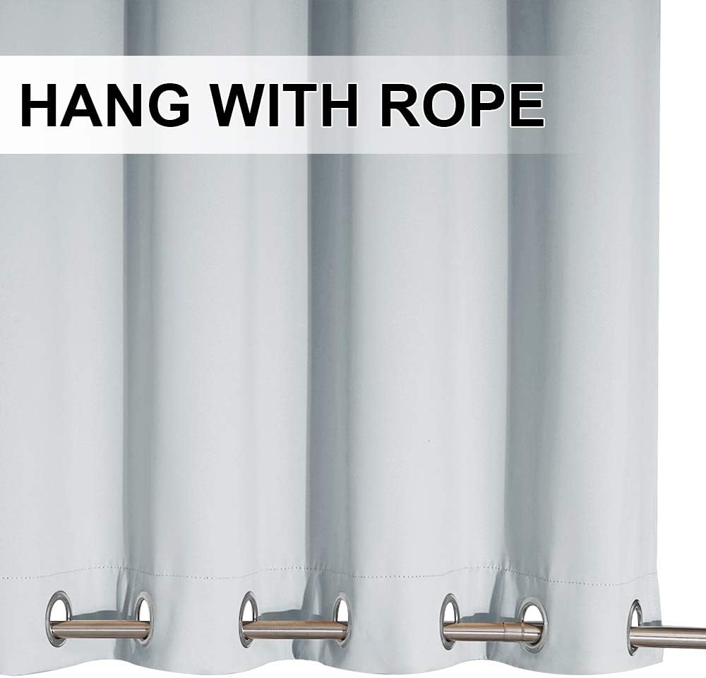 Close-up of light blue blackout curtain panel with silver grommet top on a metal rod
