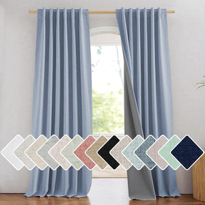 Light blue textured blackout curtains on a wooden rod, with dark lining visible. Fabric swatches.