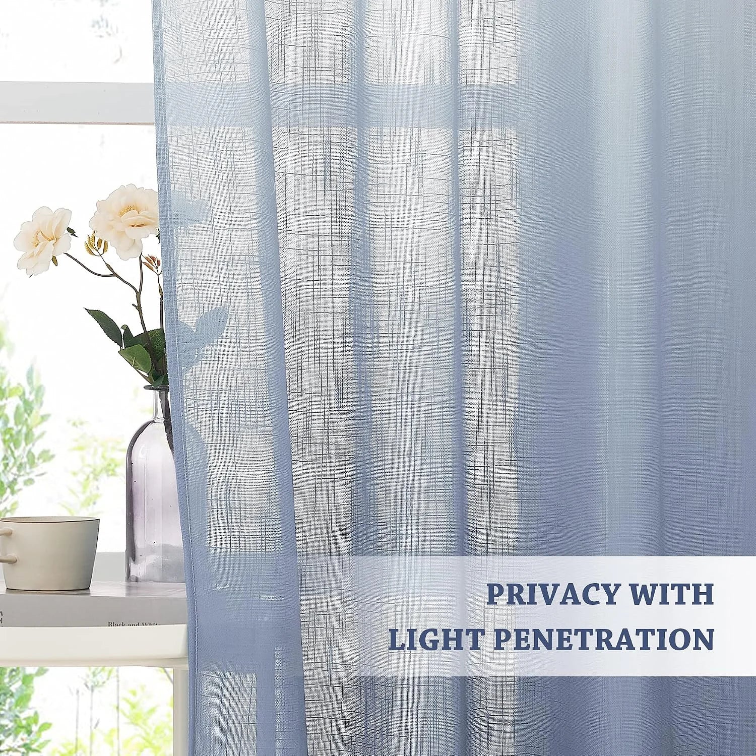Light blue sheer linen-look curtain filtering sunlight by a window with flowers