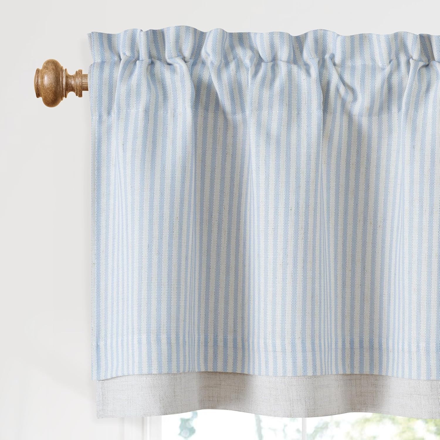 Light blue and white striped rod pocket cafe curtain with natural bottom, on wooden rod.