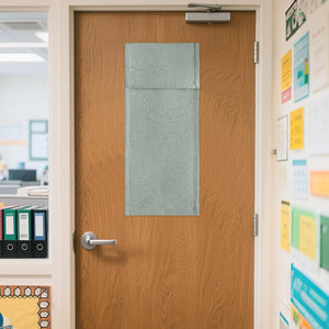 Textured light gray fabric panel covering a window on a wooden office door, offering privacy.