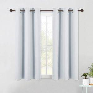 Pair of light gray solid grommet top short window curtains on a dark decorative rod.