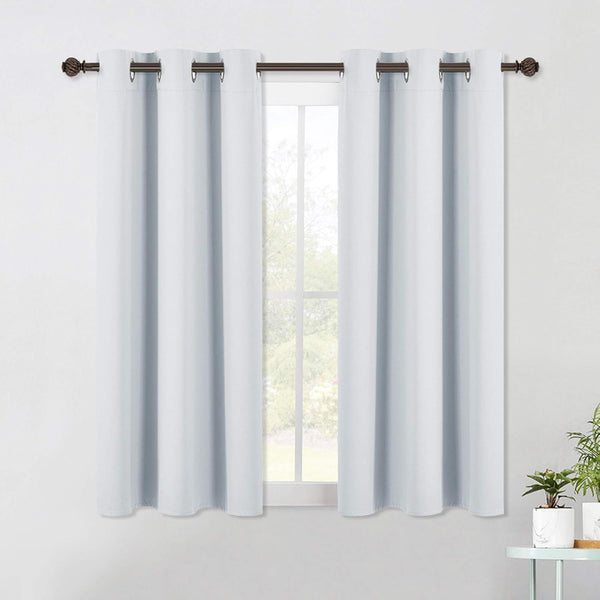 Pair of light gray solid grommet top short window curtains on a dark decorative rod.