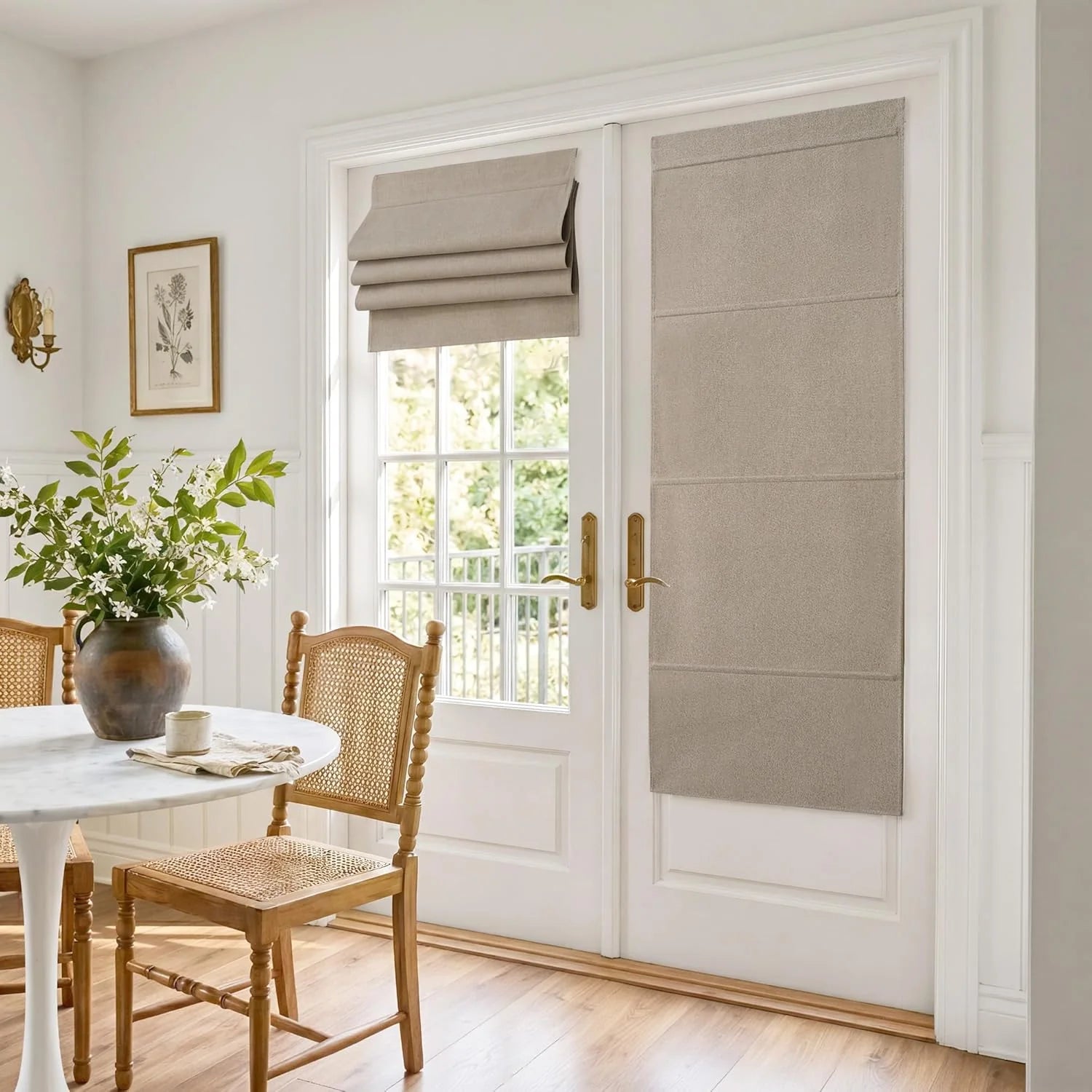 Light gray flat fold roman shades on white French doors in a dining room.