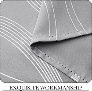 Detailed close-up of light gray curtain fabric with white linear and wavy stripes. Shows neatly stitched hem for quality.