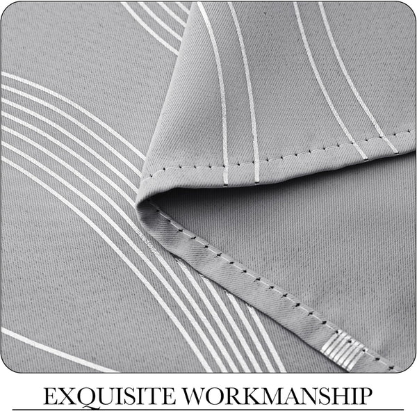 Detailed close-up of light gray curtain fabric with white linear and wavy stripes. Shows neatly stitched hem for quality.