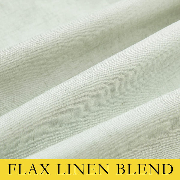Textured light green flax linen blend fabric displaying its natural weave and subtle, flowing folds.