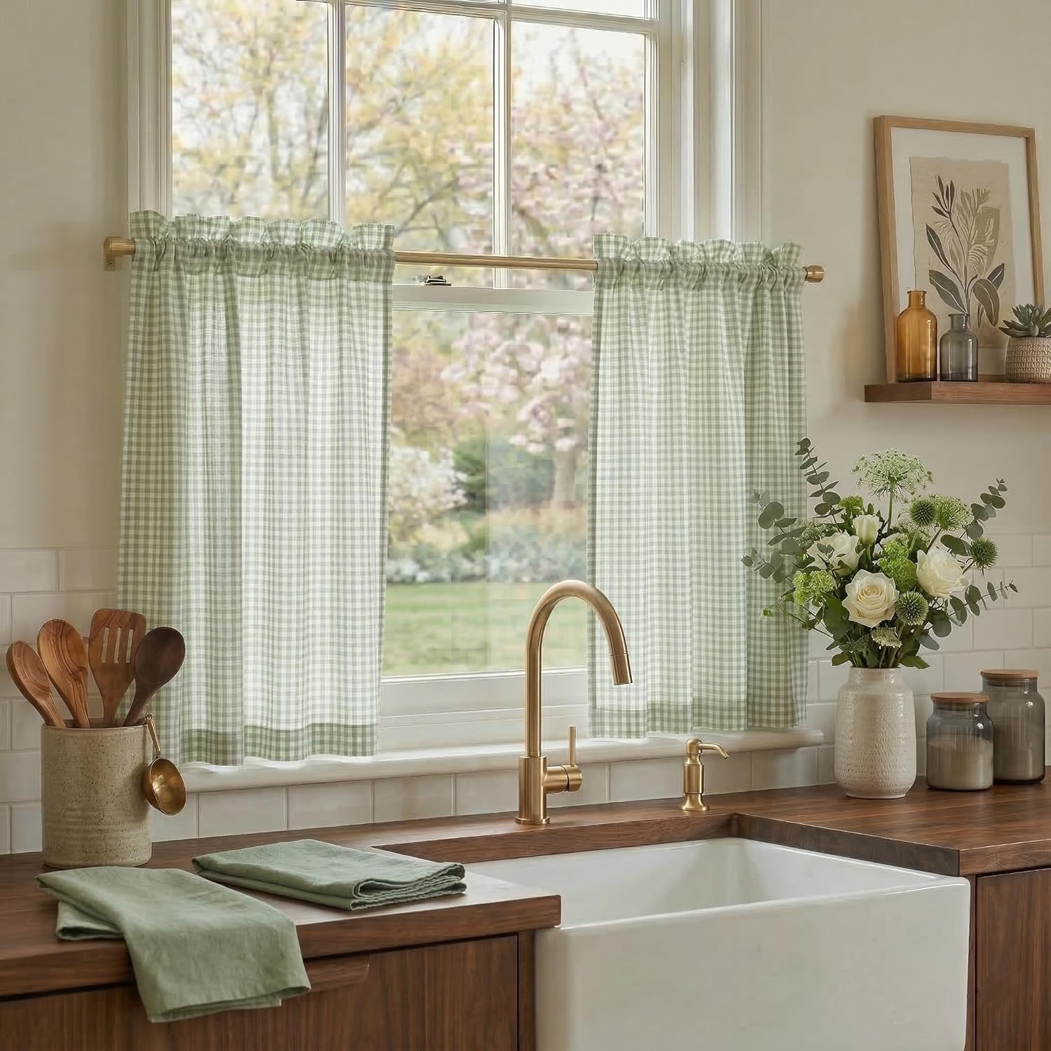 Light green and white gingham ruffled cafe curtain hanging on a brass rod in a kitchen window.