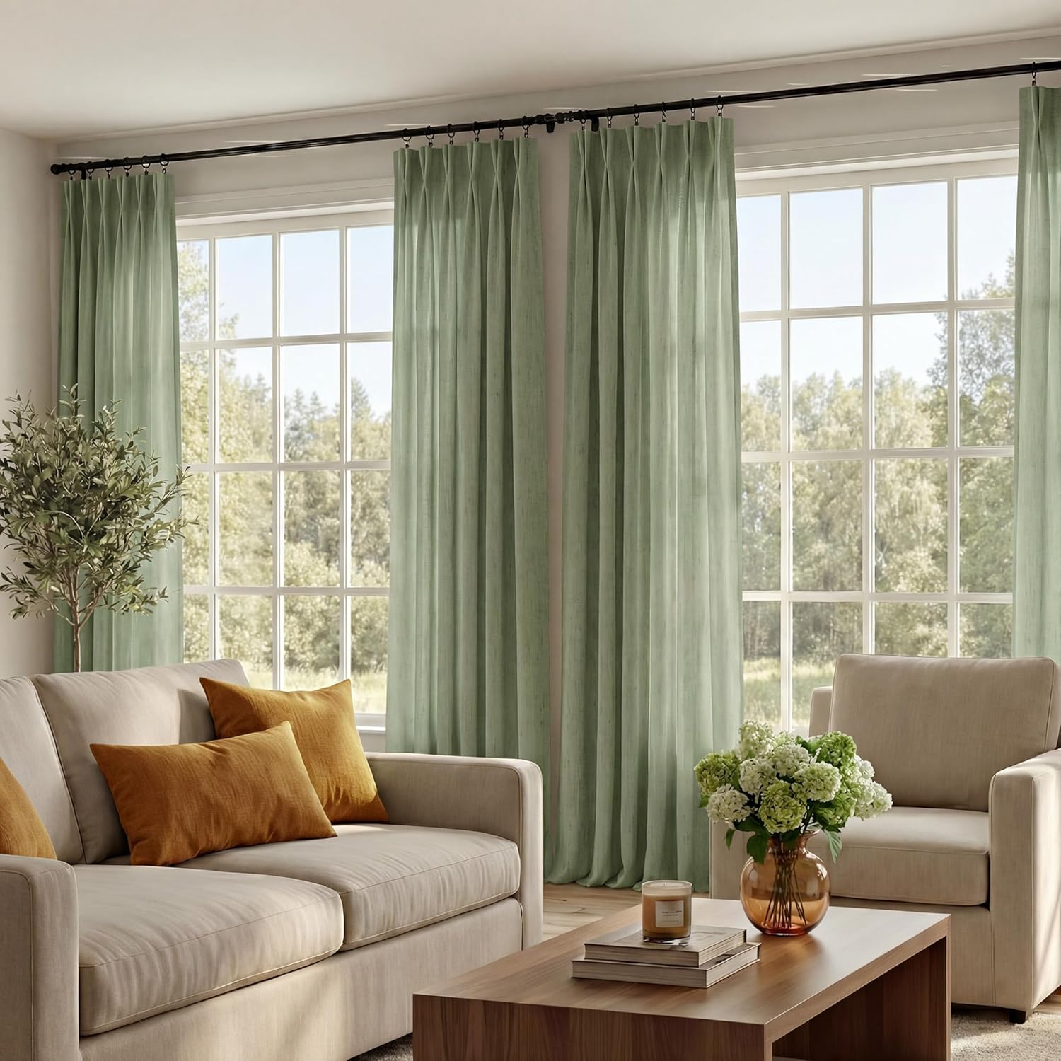 Sage green textured pinch pleat curtains hanging in a sunny living room, filtering natural light.