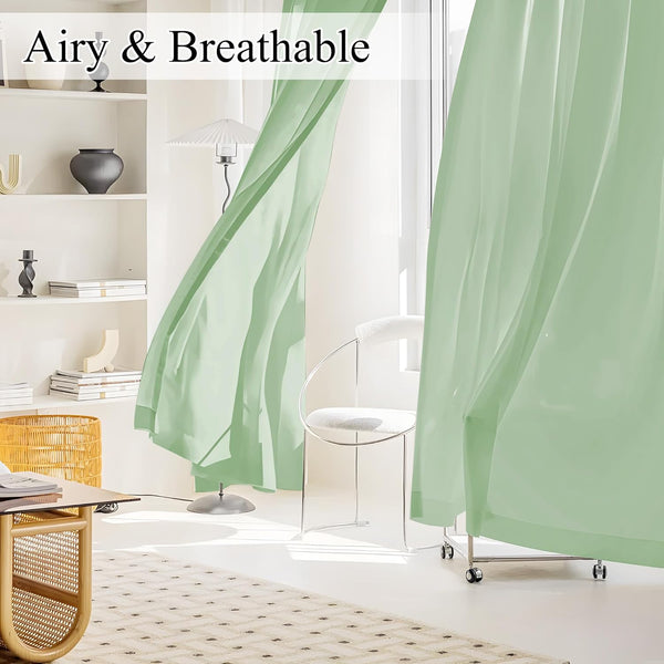 Airy light green sheer curtains gently blowing, filtering sunlight in a bright modern room.