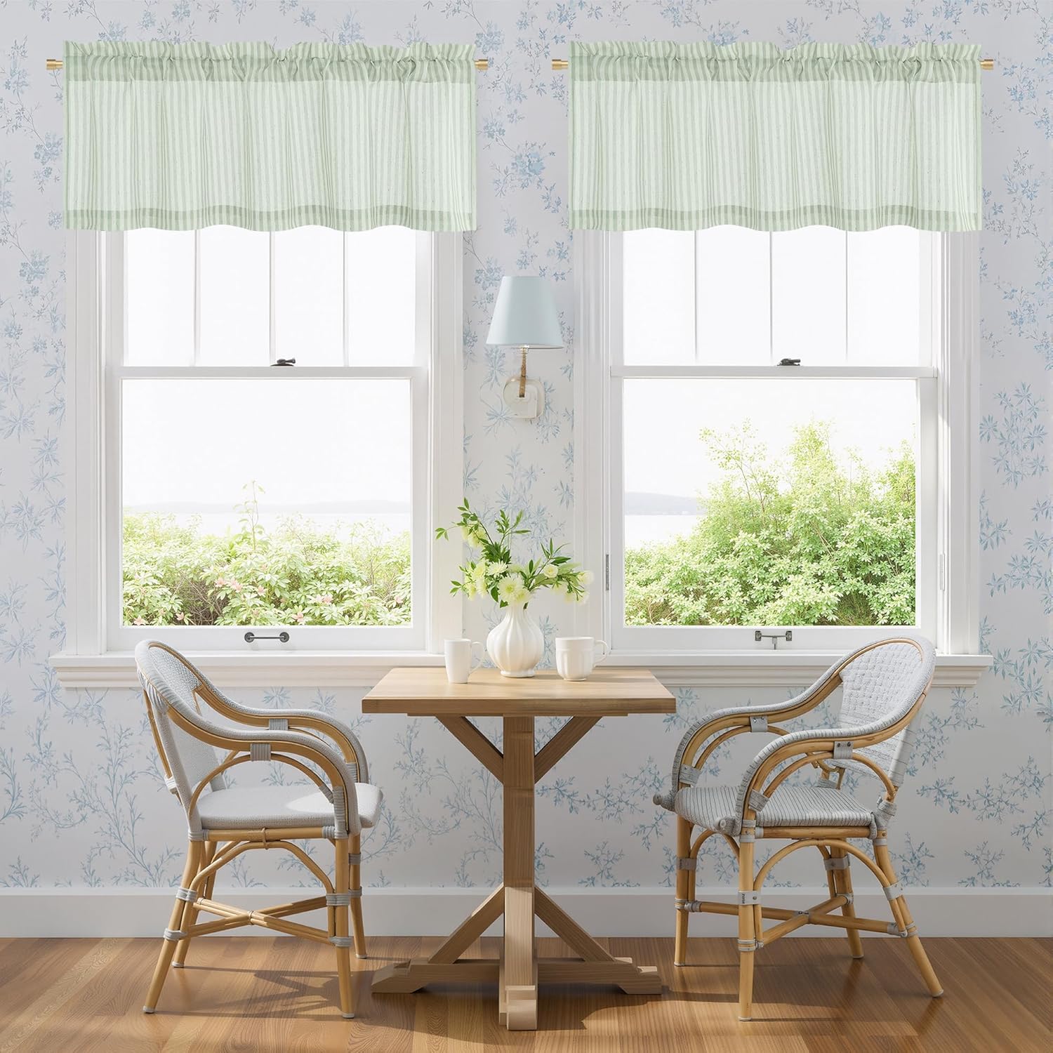 Light green and white striped ruffled kitchen valances with a rod pocket top above two windows.