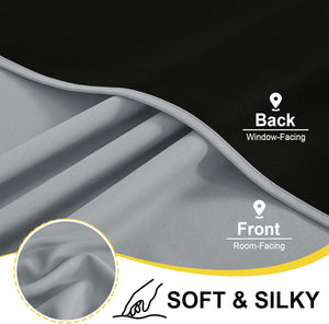 Detailed view of light grey room-facing blackout curtain fabric with a soft, silky texture and dark black backing.