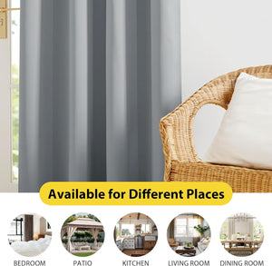 Light grey room darkening curtains with vertical folds beside a window and wicker chair.