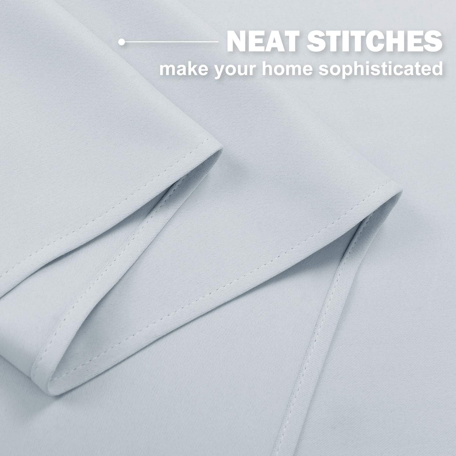 Pale grey curtain fabric with neat, even stitches along the professionally finished edges.