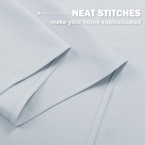 Pale grey curtain fabric with neat, even stitches along the professionally finished edges.