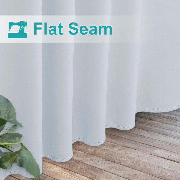 Light grey curtain with visible flat seam construction and decorative scalloped hem above a wooden floor.