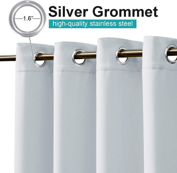Light grey curtain with silver stainless steel grommets, 1.6 inches in diameter, on a golden rod.