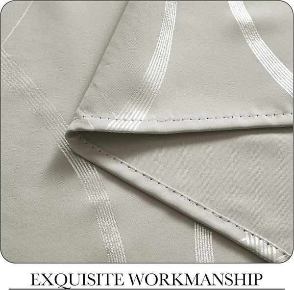 Close-up of light grey fabric with shimmering vertical silver stripes and neat, detailed stitching along the hem.