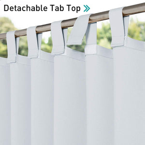 Close-up of light grey curtains with visible detachable tab tops using hook-and-loop fasteners, hanging on a golden curtain rod.