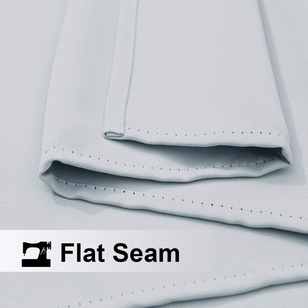 Close-up of light grey woven fabric showing a neat, durable flat seam with visible stitching.