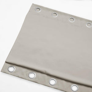 Light grey curtain panel with silver grommet rings visible along the top. Smooth, substantial fabric.