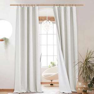 Light grey textured linen curtains with visible white lining, hung on a wooden rod.