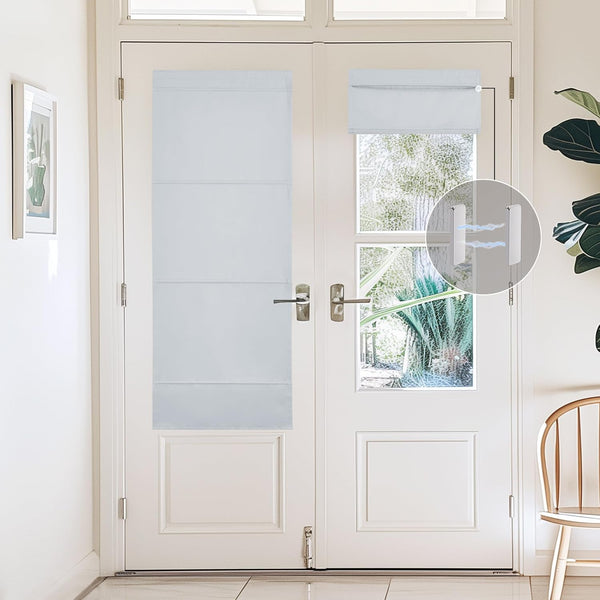 Light grey cordless roman door shades with magnetic attachment on two white French door windows, one fully extended for privacy.