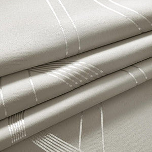 Textured light grey fabric with shimmering silver geometric line pattern, folded to show its elegant drape.