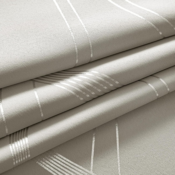 Textured light grey fabric with shimmering silver geometric line pattern, folded to show its elegant drape.
