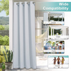 Light grey outdoor privacy curtain with metal grommet top, hanging on a sunny patio setting.