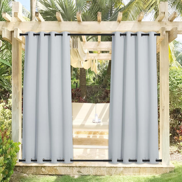 Light grey outdoor curtains with black grommets, secured top and bottom on a patio pergola.