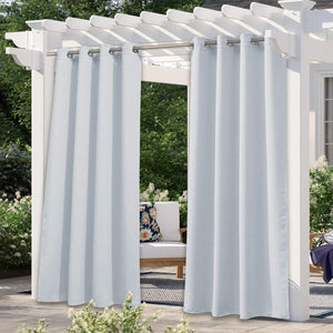Light grey outdoor curtains with silver grommets on a white pergola, offering shade for a patio.