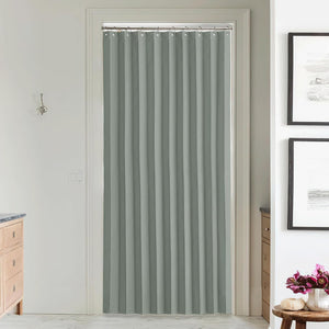 Full-length light grey pleated fabric doorway curtain hanging from a silver rod, providing privacy in a room.