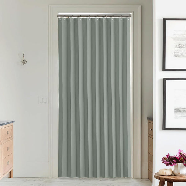 Full-length light grey pleated fabric doorway curtain hanging from a silver rod, providing privacy in a room.