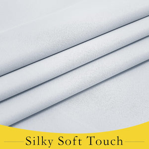 Close-up of smooth light grey fabric, highlighting its soft, silky texture and gentle folds.