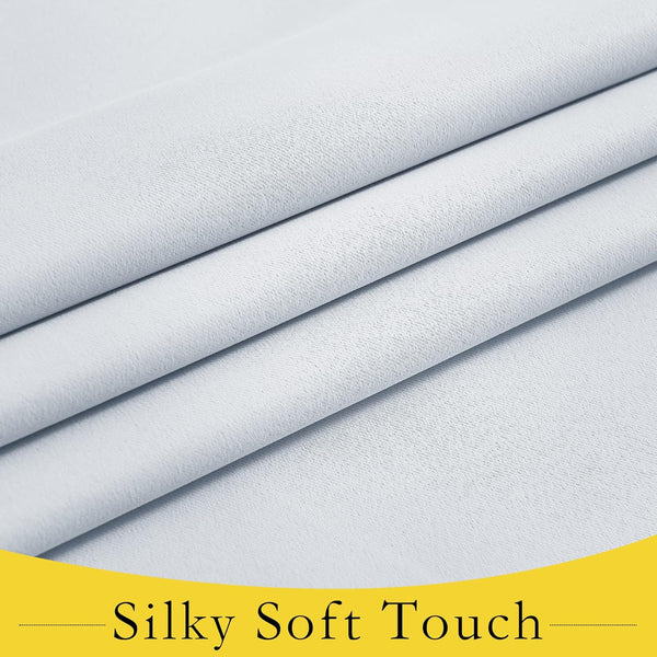 Close-up of smooth light grey fabric, highlighting its soft, silky texture and gentle folds.