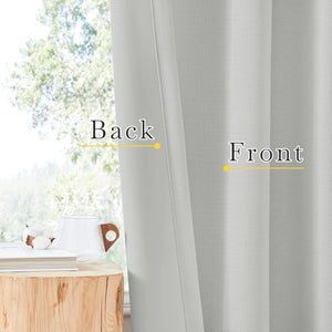 Light grey curtain fabric showing textured front and smoother back, next to a sunlit window.