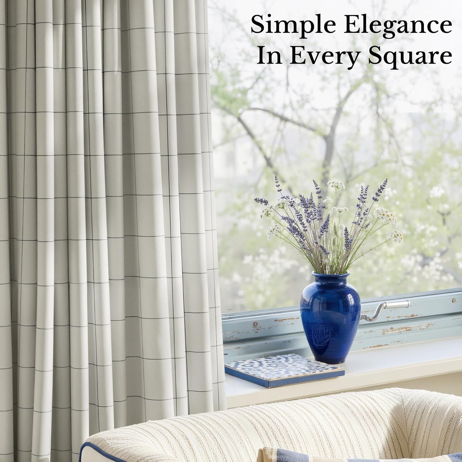 Elegant light grey pleated curtains with a black windowpane grid pattern hanging next to a bright window.